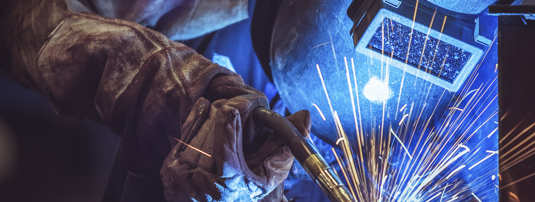 Person welding using PPE